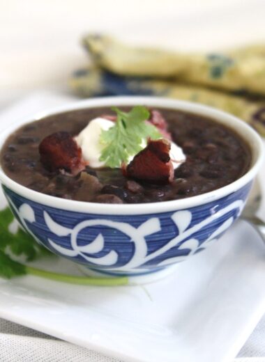 Cuban Black Bean Soup with Smoked Ham Hock is made with black beans simmered with smoked ham hocks and aromatic ingredients like onions, garlic, bell peppers, and spices. The infusion of flavors creates a deeply satisfying and robust soup.