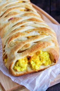 This Ham, Egg, and Cheddar Breakfast Braid is loaded with scrambled eggs, diced ham, peppers, and lots of cheese - perfect for serving a crowd!