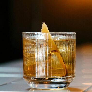 This Japanese Old Fashioned features Suntory Hibiki Whiskey as its star ingredient, complemented by sugar, yuzu bitters for a zesty twist, and a garnish of orange peel.