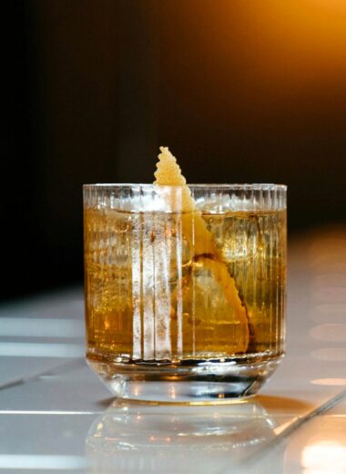 This Japanese Old Fashioned features Suntory Hibiki Whiskey as its star ingredient, complemented by sugar, yuzu bitters for a zesty twist, and a garnish of orange peel.