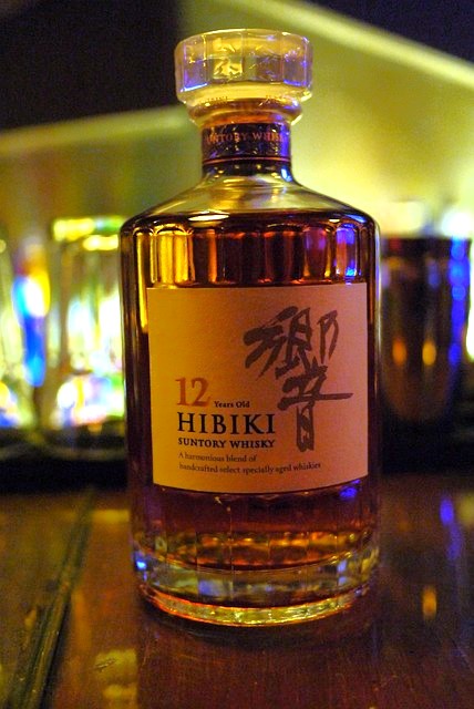 This Japanese Old Fashioned features Suntory Hibiki Whiskey as its star ingredient, complemented by sugar, yuzu bitters for a zesty twist, and a garnish of orange peel.