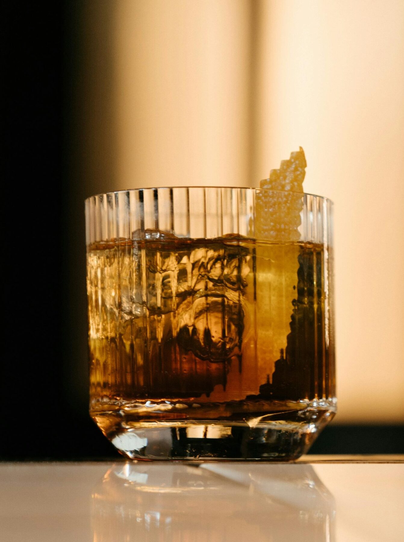 This Japanese Old Fashioned features Suntory Hibiki Whiskey as its star ingredient, complemented by sugar, yuzu bitters for a zesty twist, and a garnish of orange peel.