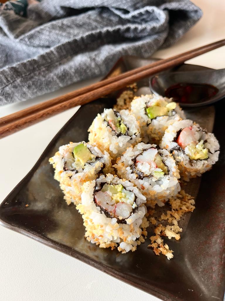 Learn how to make a delicious California Crunchy Sushi Roll at home with crispy panko breadcrumbs, creamy avocado, cucumber, and imitation crab for a fun and flavorful sushi experience.