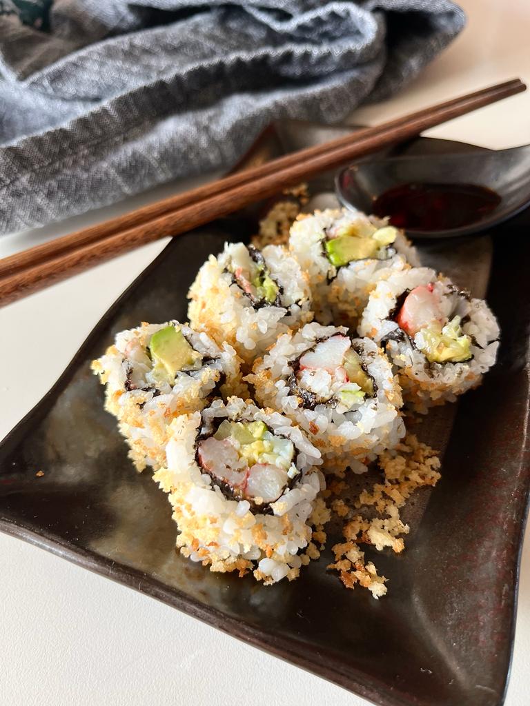 Learn how to make a delicious California Crunchy Sushi Roll at home with crispy panko breadcrumbs, creamy avocado, cucumber, and imitation crab for a fun and flavorful sushi experience.