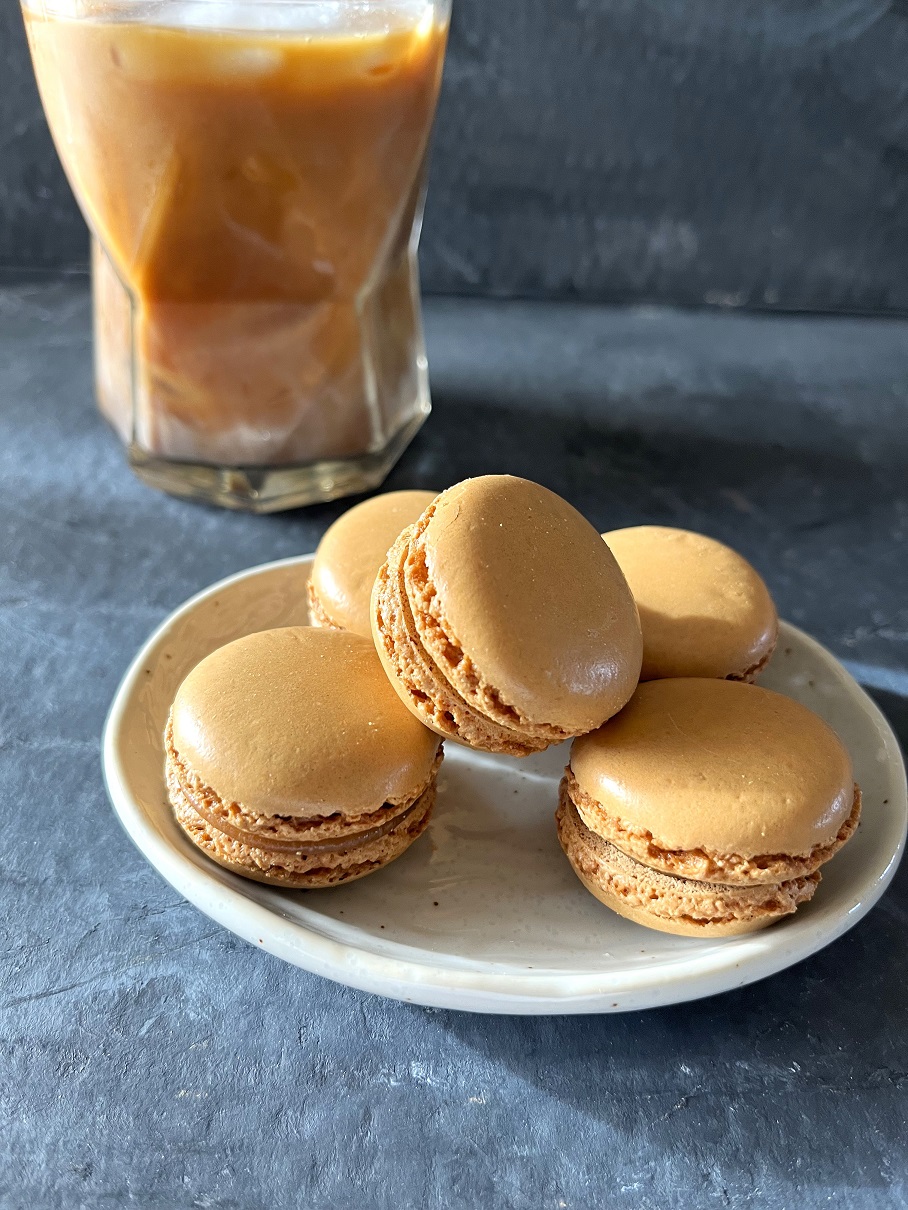 This easy coffee macaron recipe with espresso buttercream is perfect for coffee lovers, combining a rich coffee flavor with the delicate texture of French macarons.