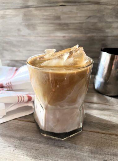 This Iced Caramel Macchiato Upside Down Coffee served upside down is the perfect blend of sweet vanilla, rich espresso, poured in first, followed by the creamy milk, resulting in a smoother, more integrated flavor profile.